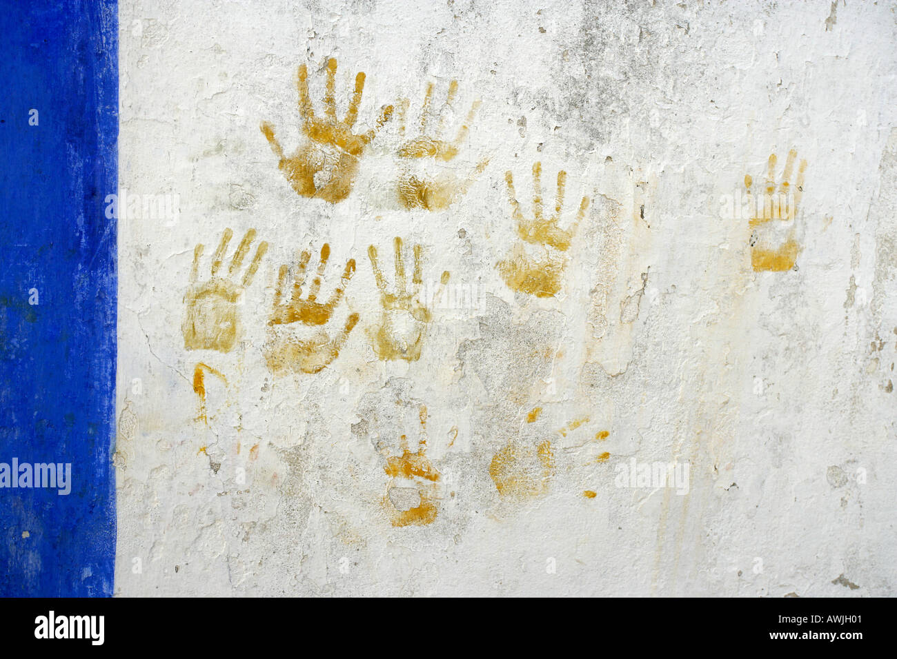 Painted hand prints made on a white washed wall found in Óbidos Portugal Stock Photo