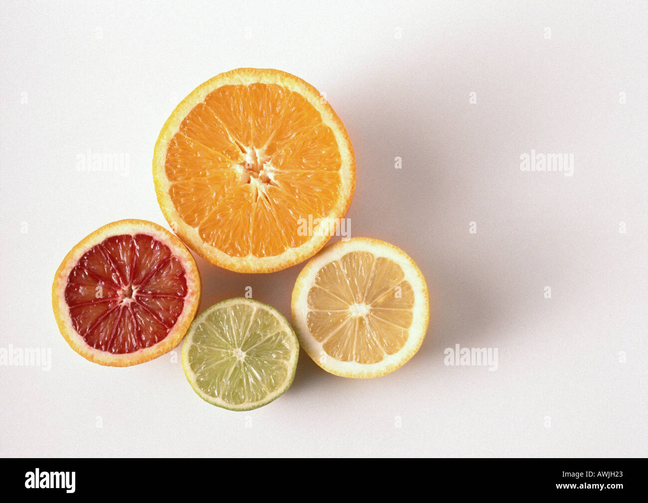 Cross sections of orange, blood orange, lemon, lime, close-up, high angle view, white background Stock Photo