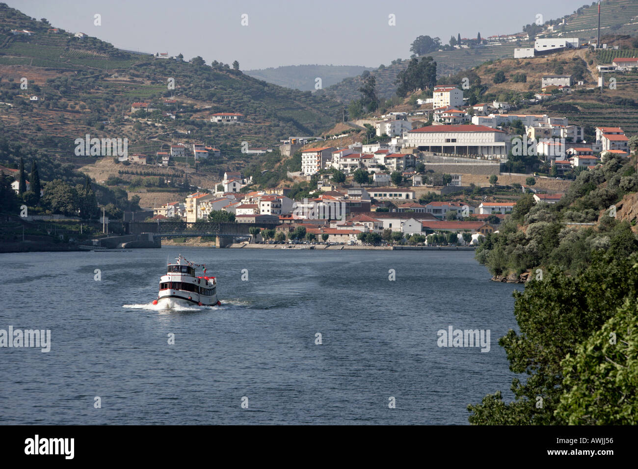 A passenger tour boat leaves the village of Pinhão on a tour of the Douro Valley in central north Portugal Stock Photo