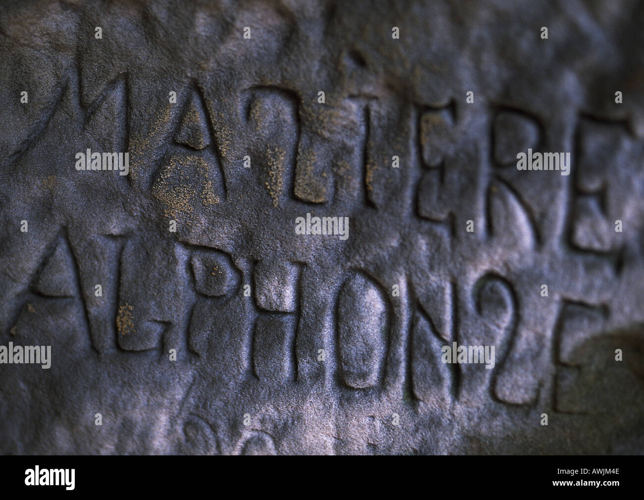 Writing engraved in stone wall. Stock Photo