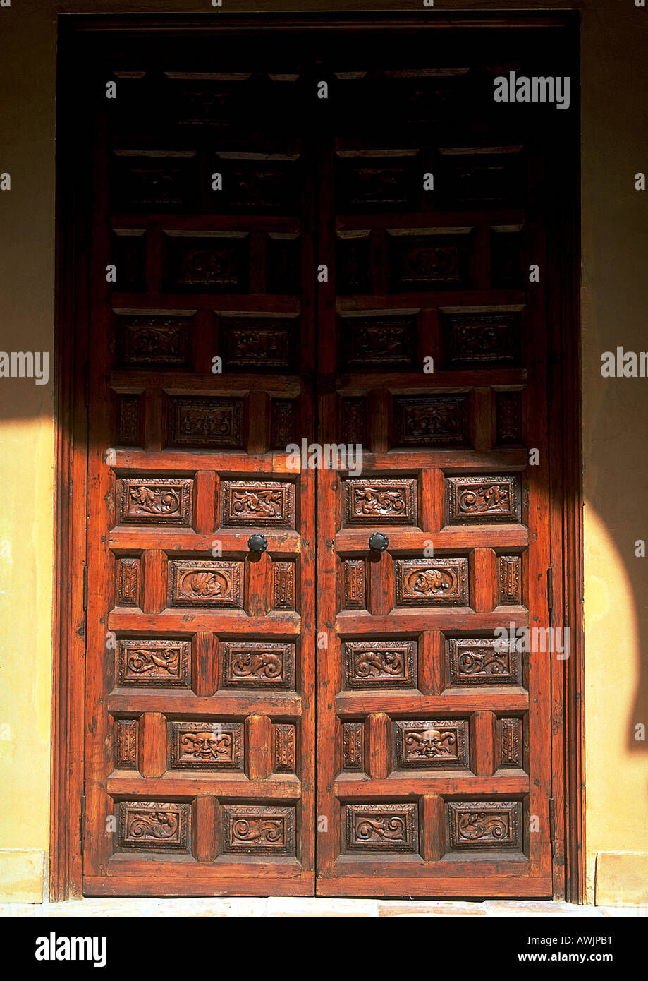 Carved wooden doors, in part shadow Stock Photo