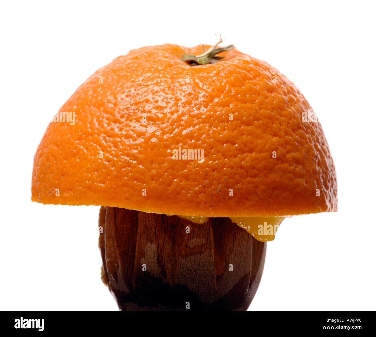 Half an orange on a wooden orange squeezer Stock Photo