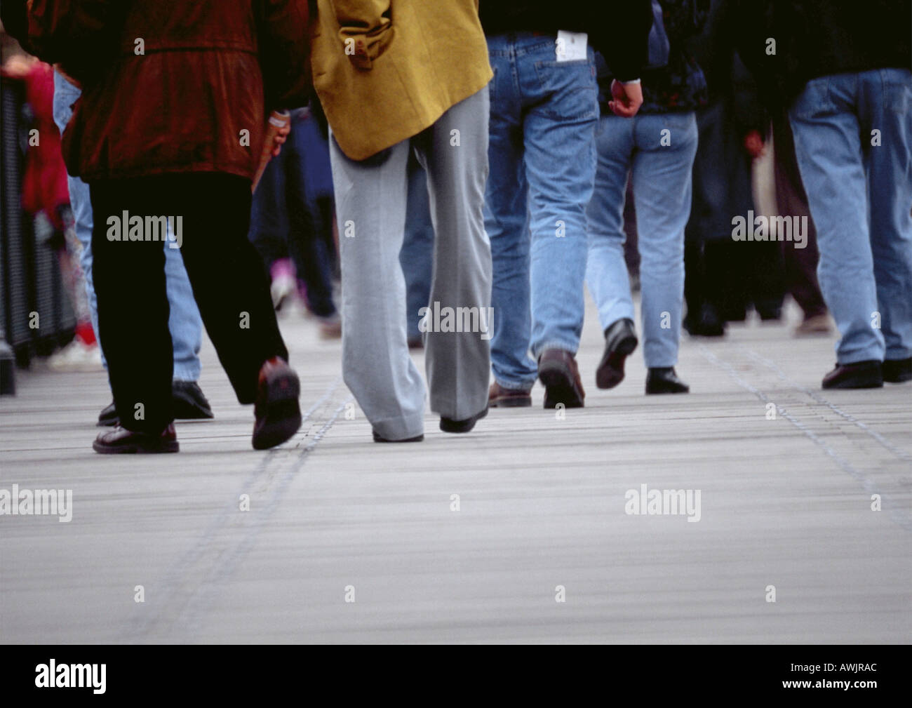 Crowd of people walking on sidewalk, cropped view, low angle Stock Photo