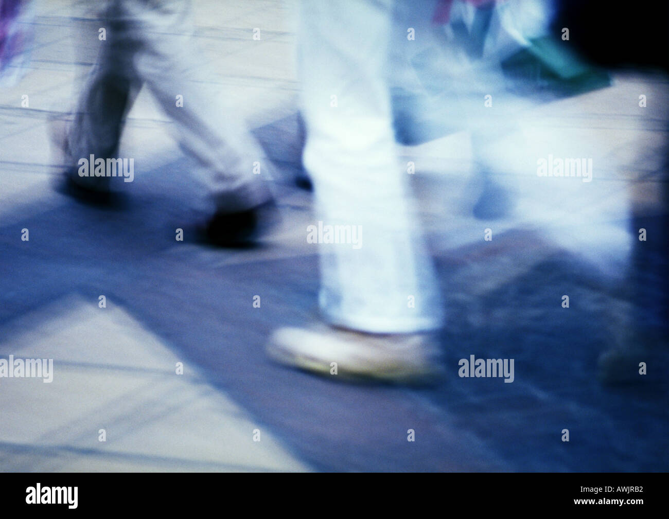 People walking on sidewalk, blurred motion Stock Photo