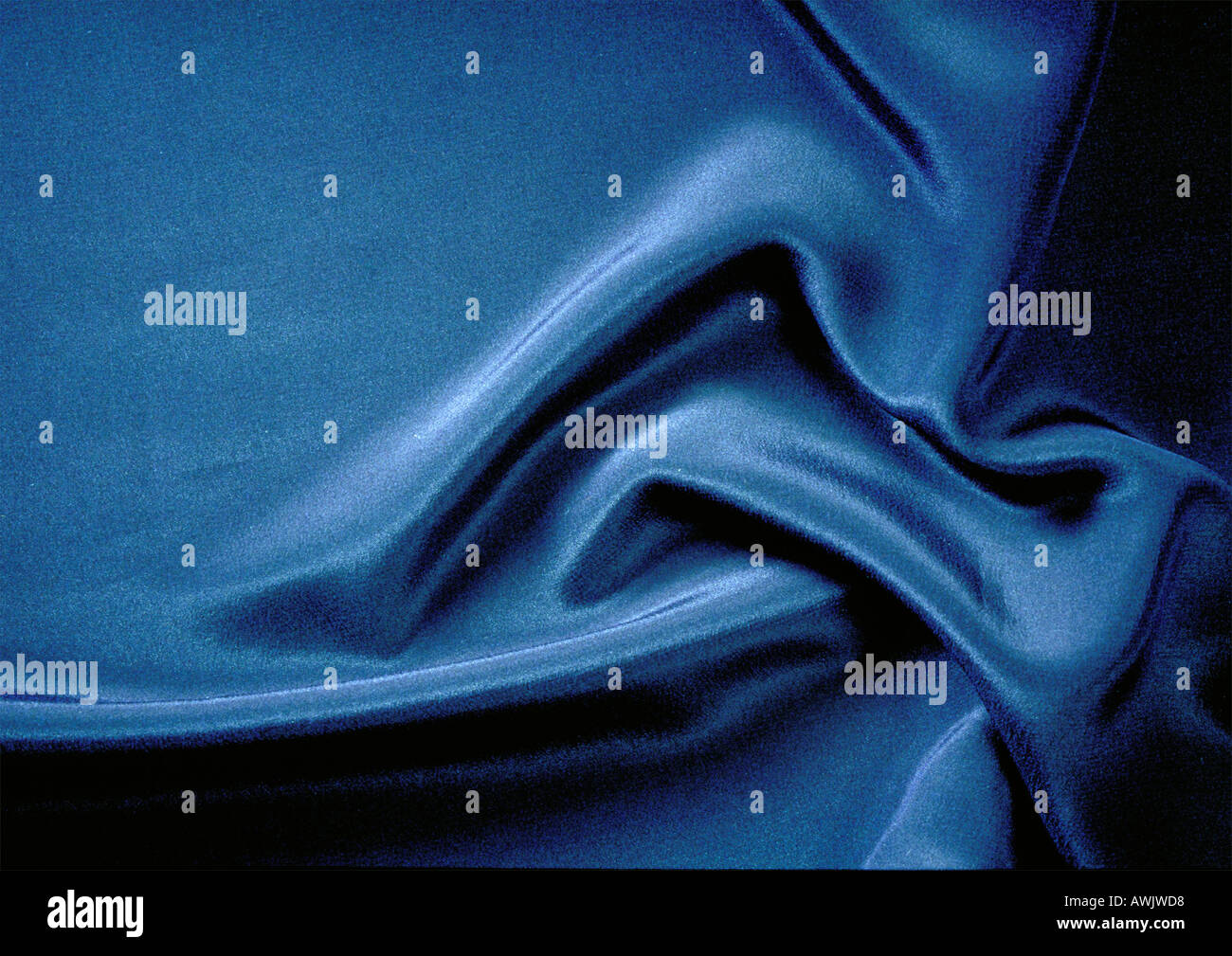 Folds in silky blue fabric, close-up, full frame Stock Photo