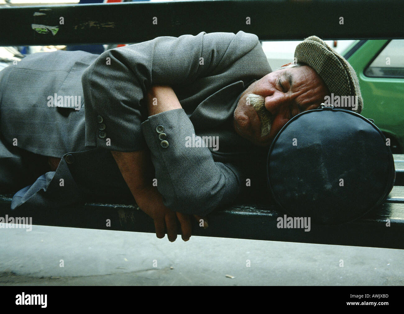 Man sleeping on park bench Stock Photo - Alamy