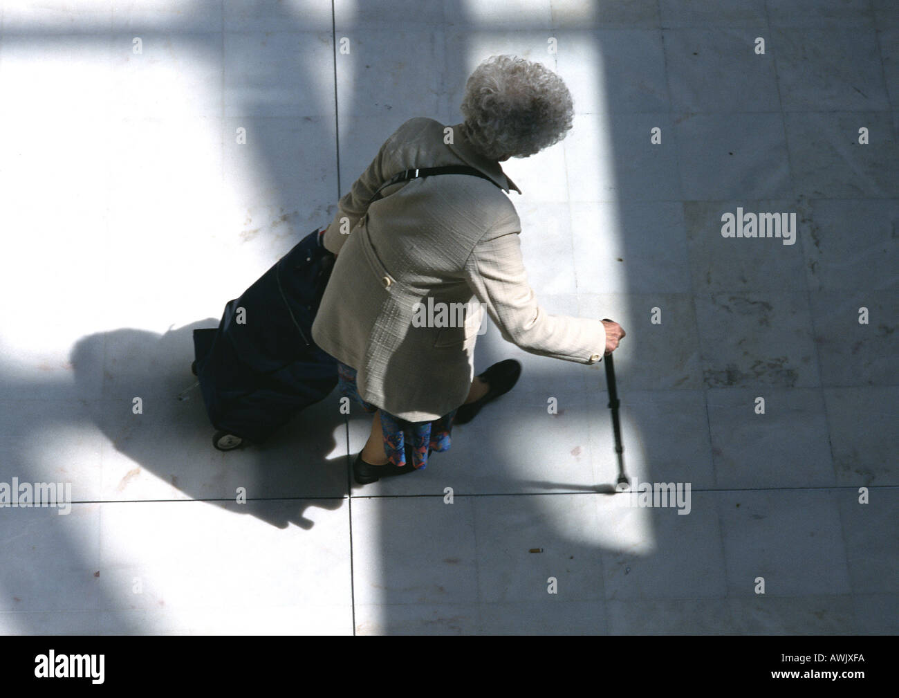 Woman walking with cane, view from above. Stock Photo