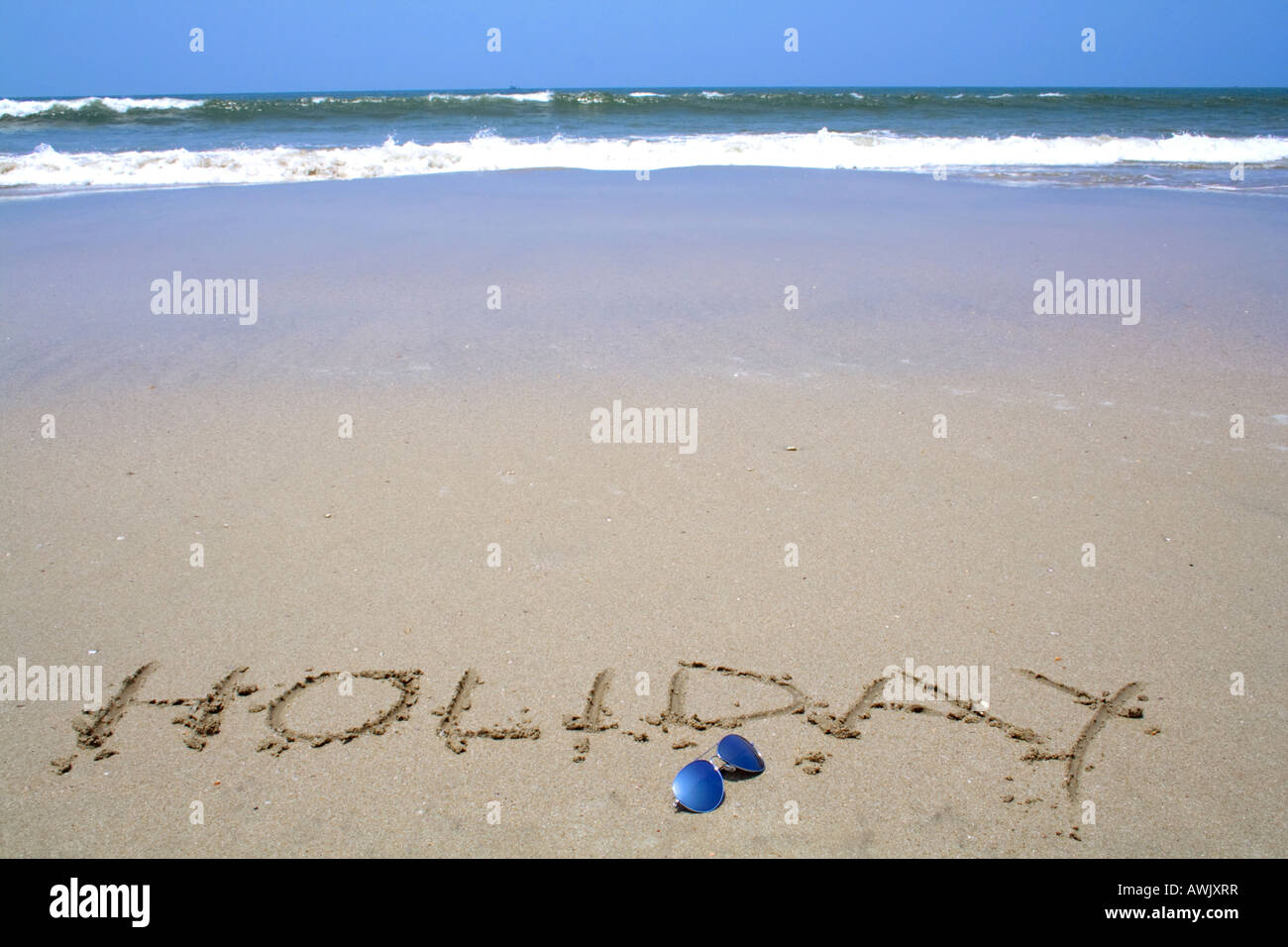 'holiday' written in the sand Stock Photo