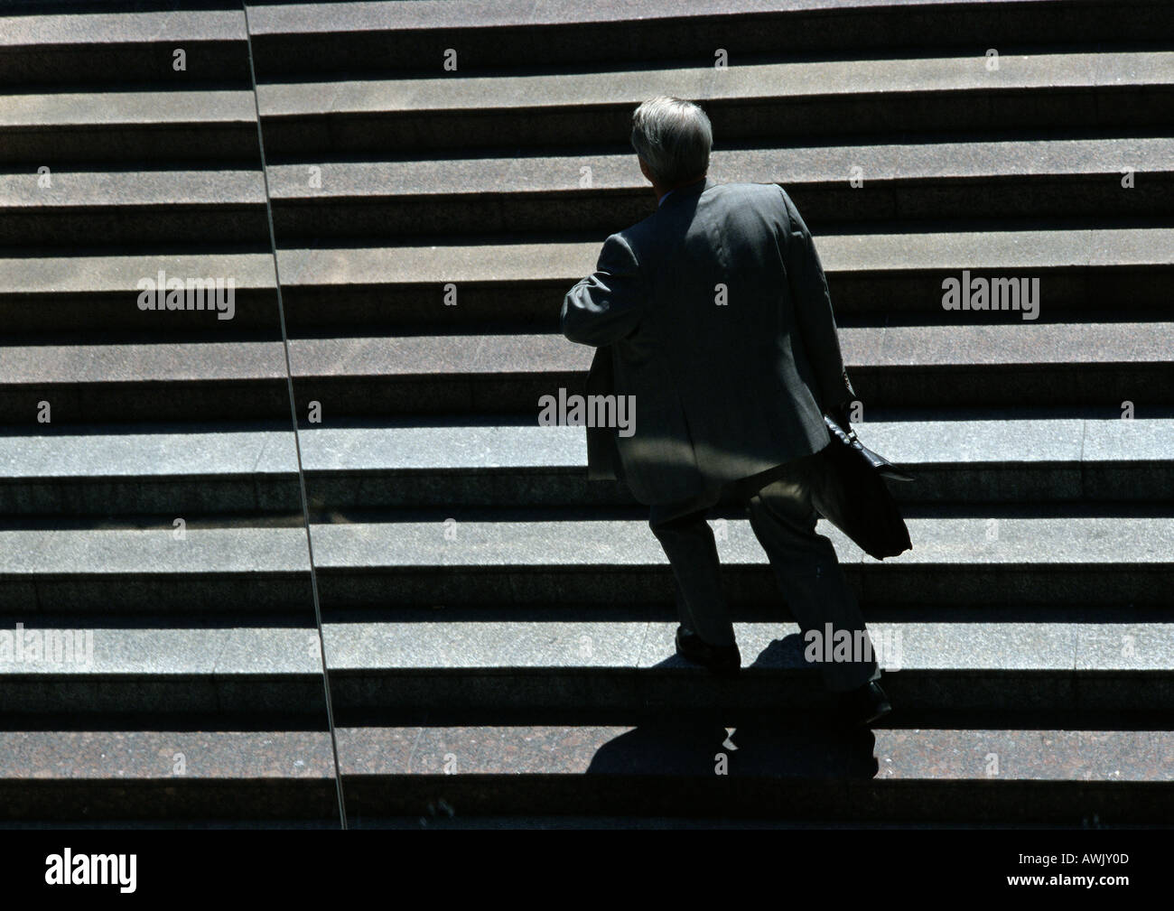 Businessman walking up stairs Stock Photo