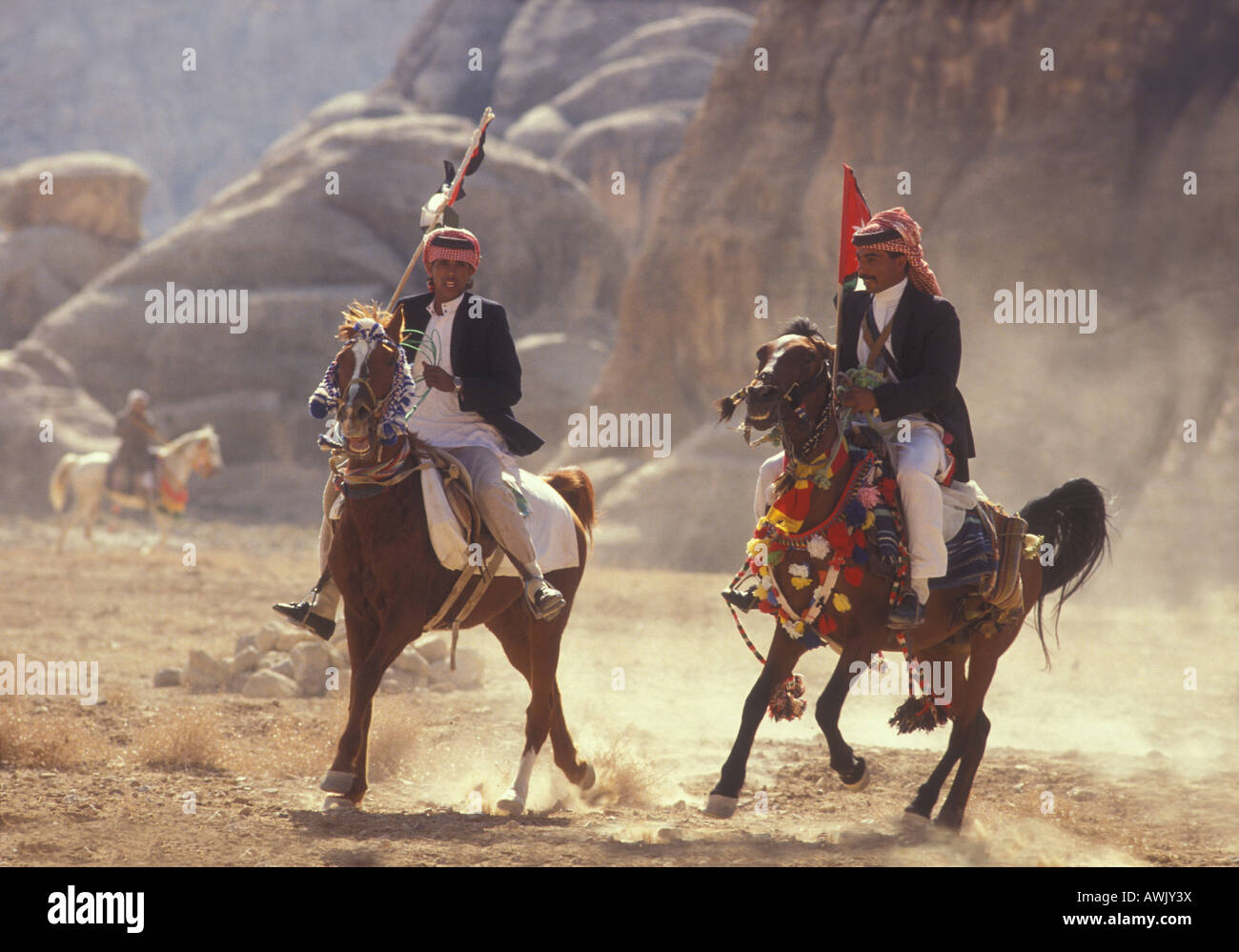 Raising dust as Arab horses and men participate in a horse race in the Jordanian desert, near Petra, Jordan Stock Photo