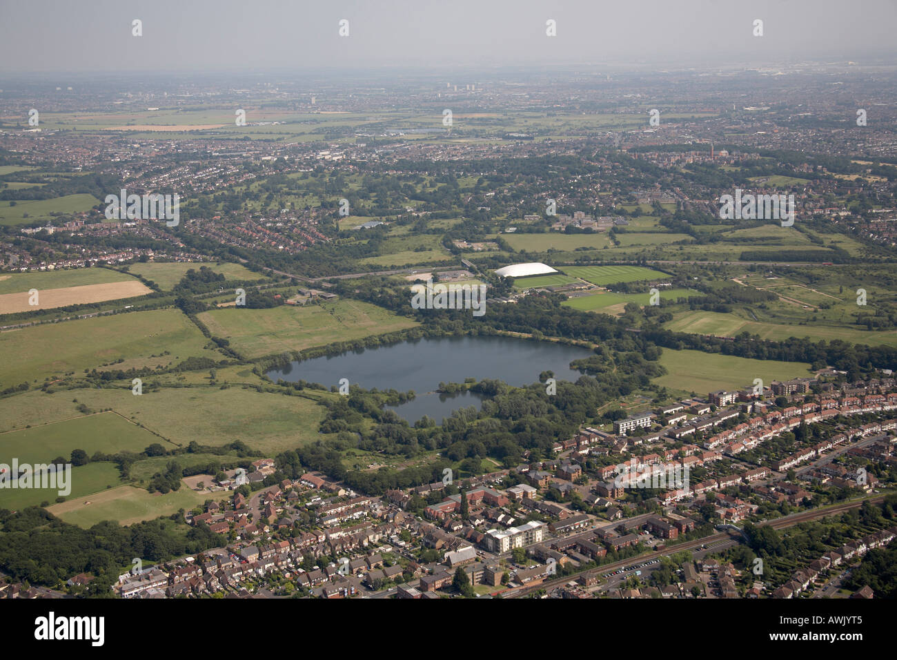 High level oblique aerial view south east of Chigwell New Barns Farm Lake London Guildhall University Sports Ground Playing Fiel Stock Photo