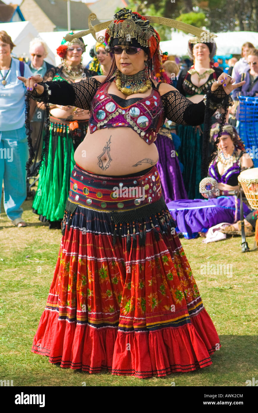 Swanage Folk Festival, fat flamboyant belly dancer, spectacular dress, troupe performing in show grounds, September,Swanage, Dorset, UK, Stock Photo
