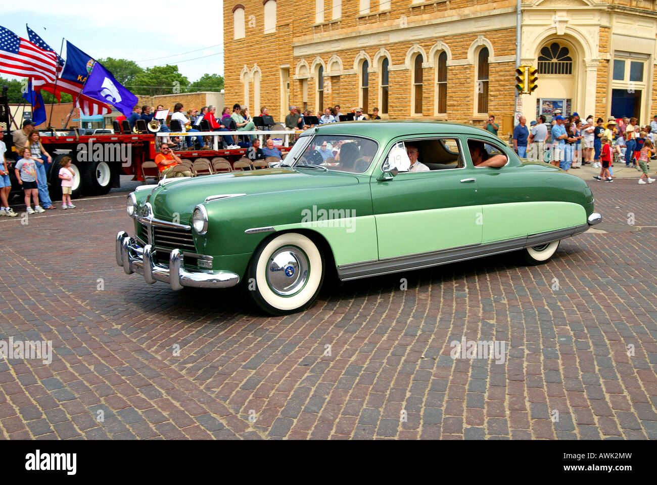 People ride in 1948 Hudson automobile in town parade Beloit Kansas USA