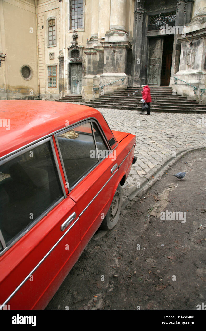 Red Lada outside the Dominican Church of the Assumption, Lviv, Ukraine. Stock Photo