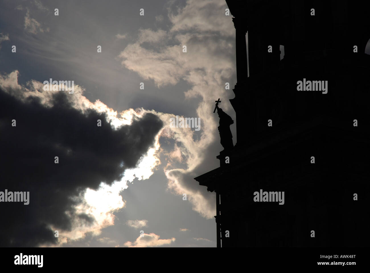 A detail of a saint holding a cross in back light at the Berlin Cathedral. Stock Photo