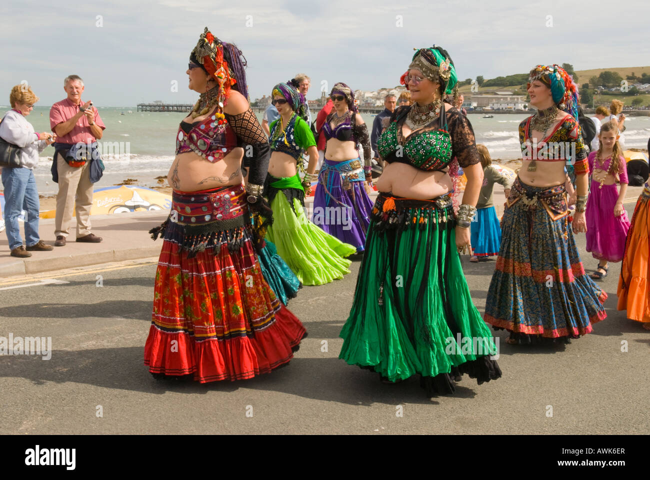 Swanage Folk Festival. eccentric extrovert belly dancers in parade of traditional dancers along sea front. September, Dorset, UK Stock Photo