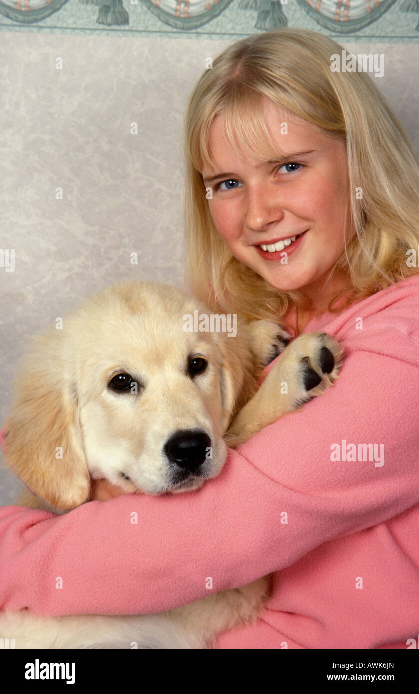 portrait blonde teenage girl with golden retriever pup Stock Photo - Alamy