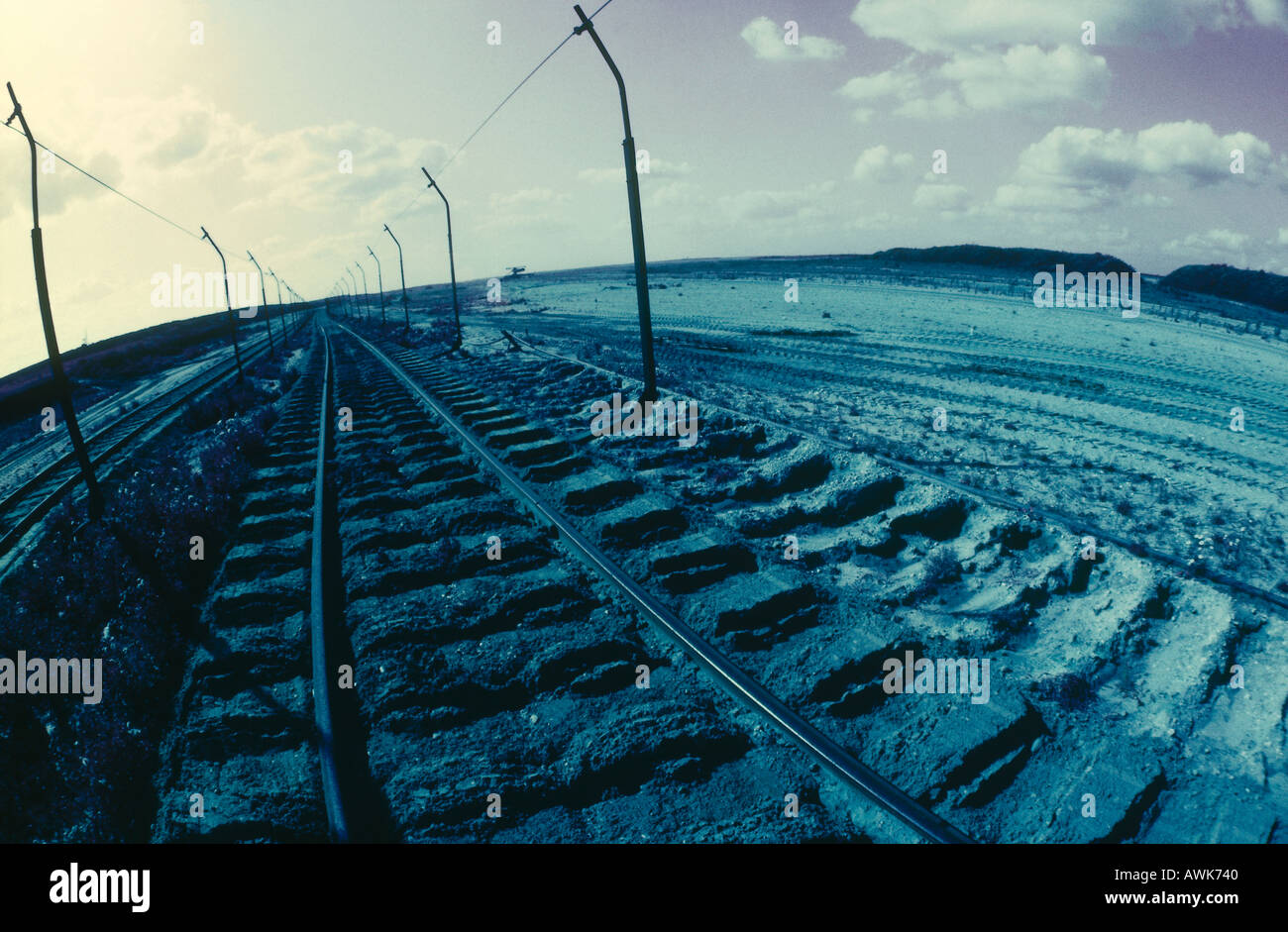 Railroad track passing through landscape Stock Photo