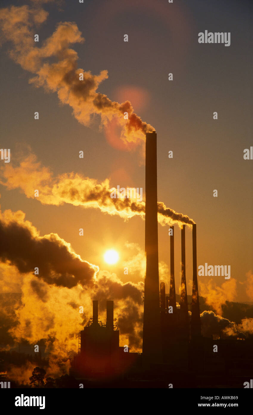 Chimneys emitting smoke at dusk Stock Photo - Alamy