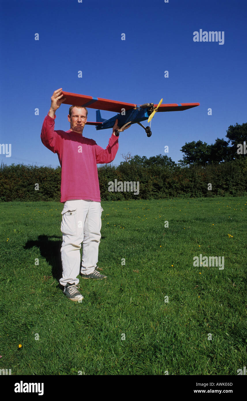 man holding remote control operated model aircraft about to launch into air uk Stock Photo