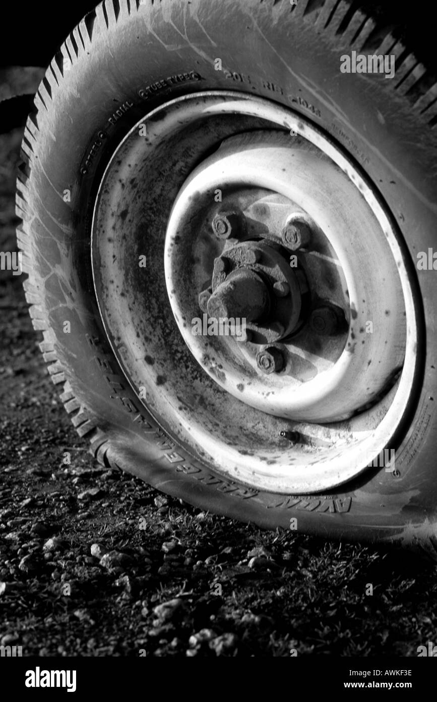 flat tyre on vehicle stuck at the side of the road uk Stock Photo