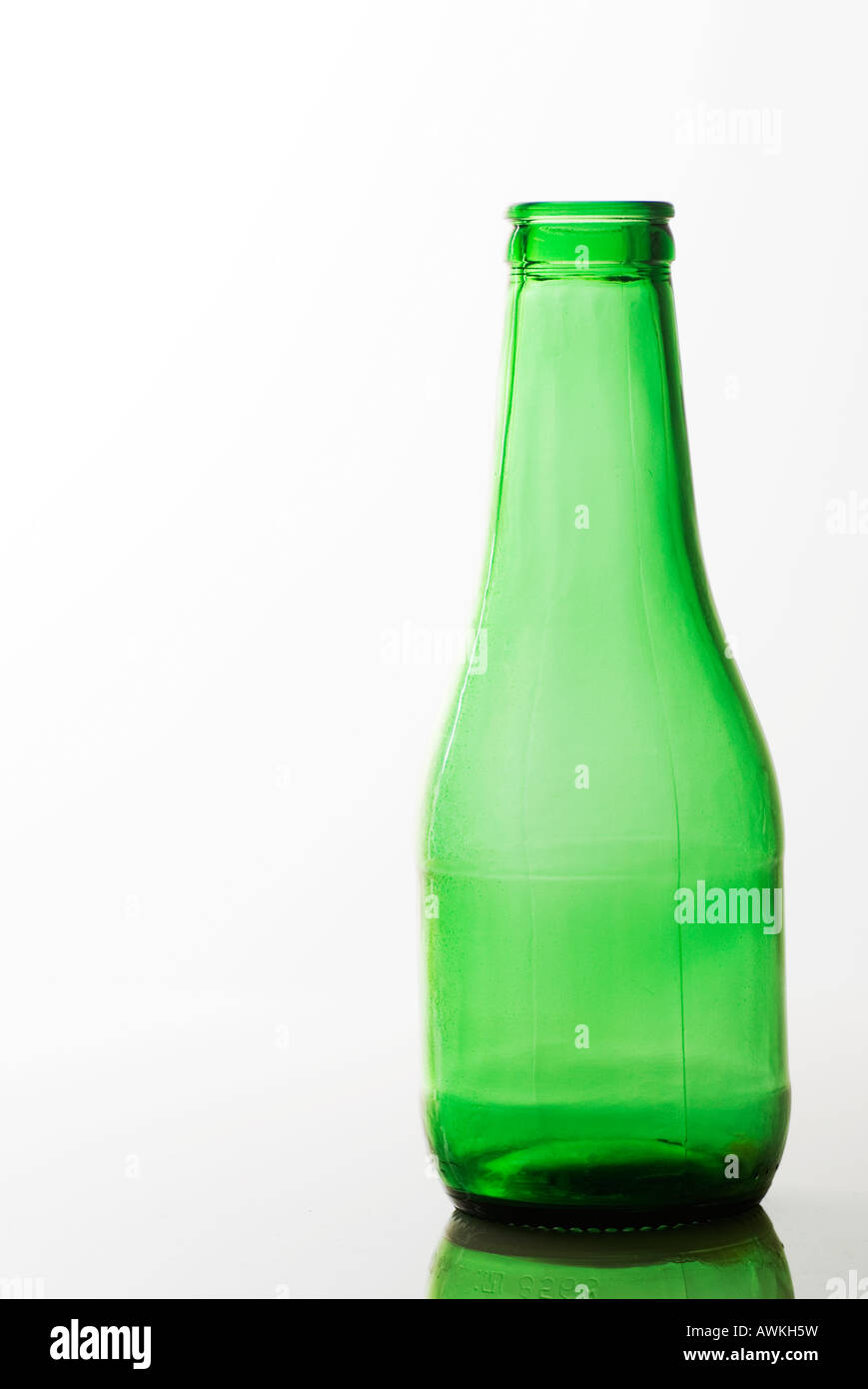 Empty green glass bottle on a white background Stock Photo - Alamy