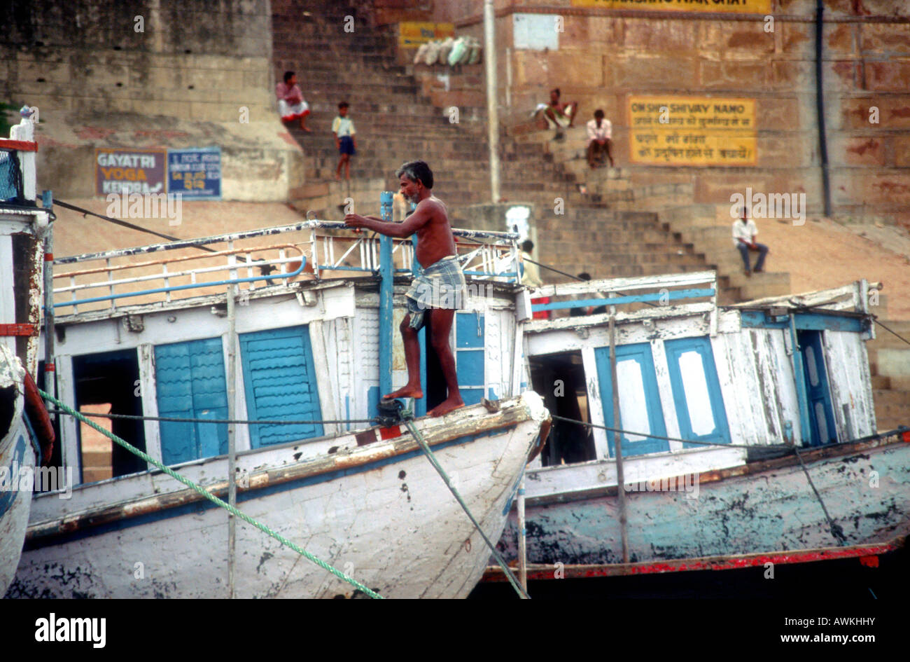Local people and boats on the banks of the river Ganges at Varanasi, India Stock Photo