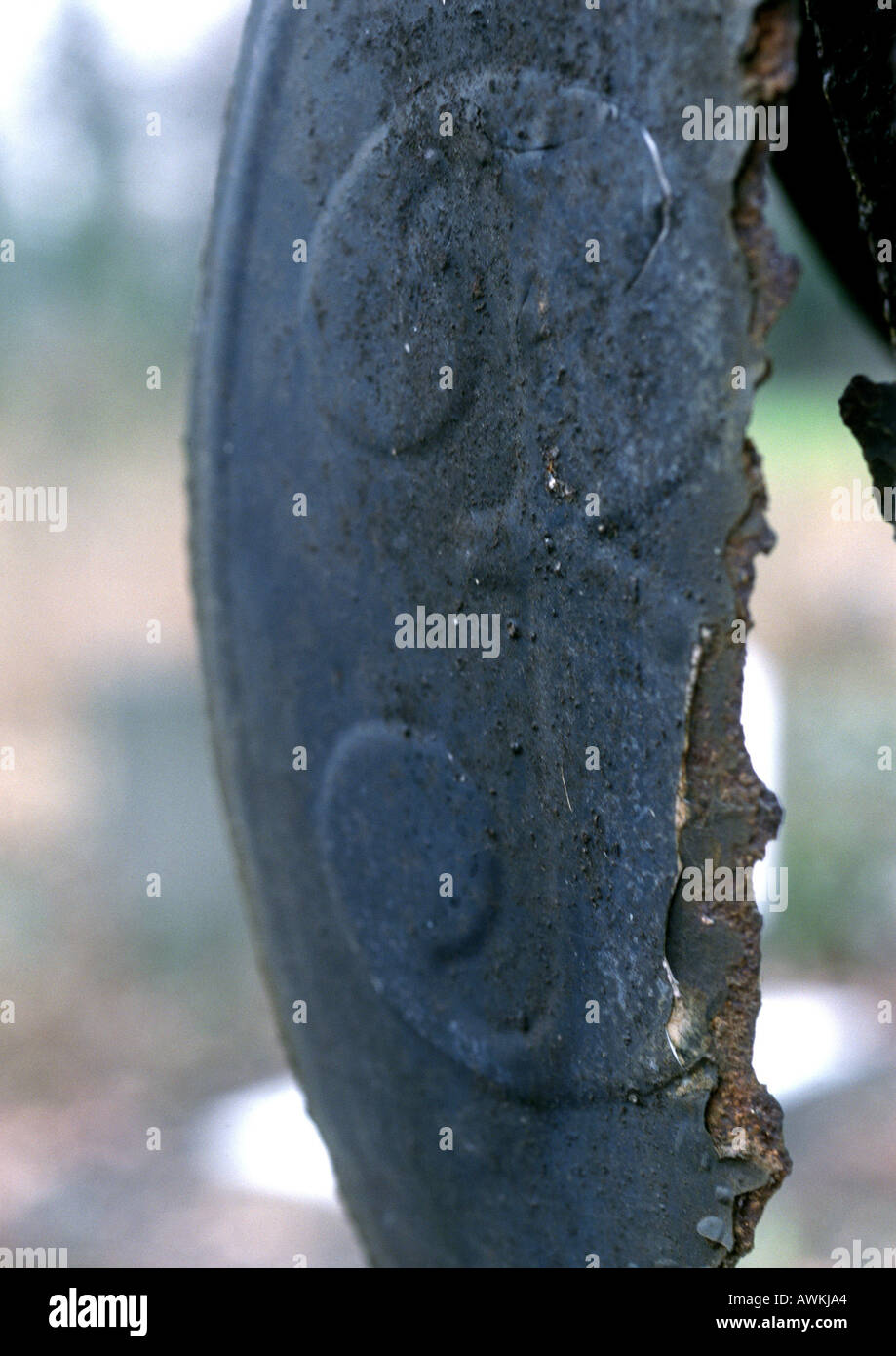 3 text embossed on broken metal surface Stock Photo