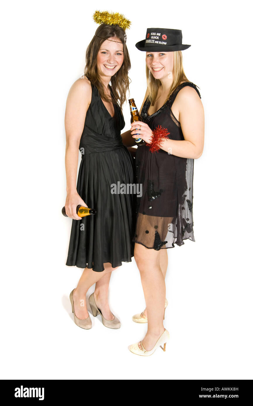 Two party girls wearing black dresses and holding bottles of beer. Stock Photo