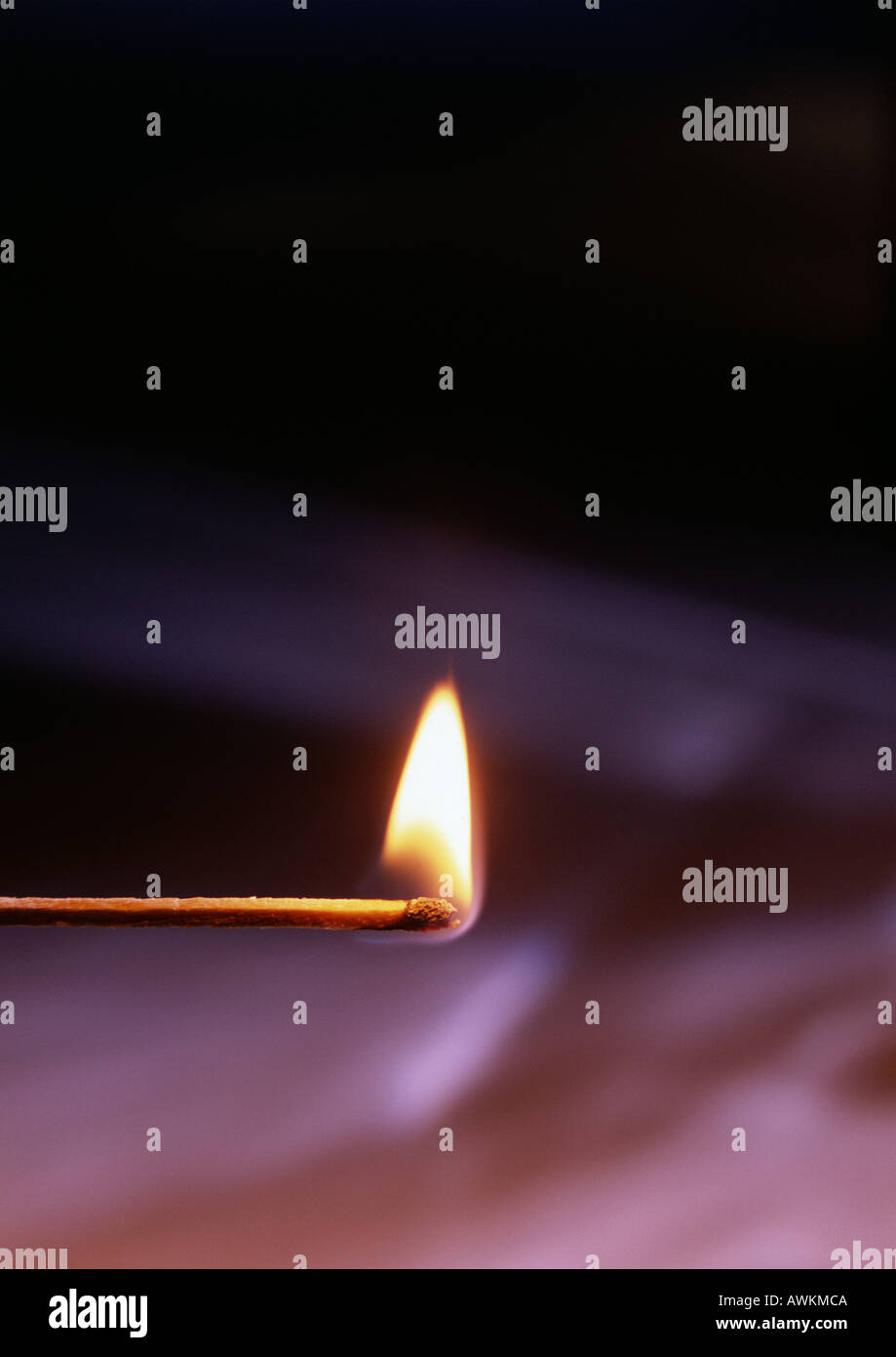 Lit match on dark background Stock Photo - Alamy