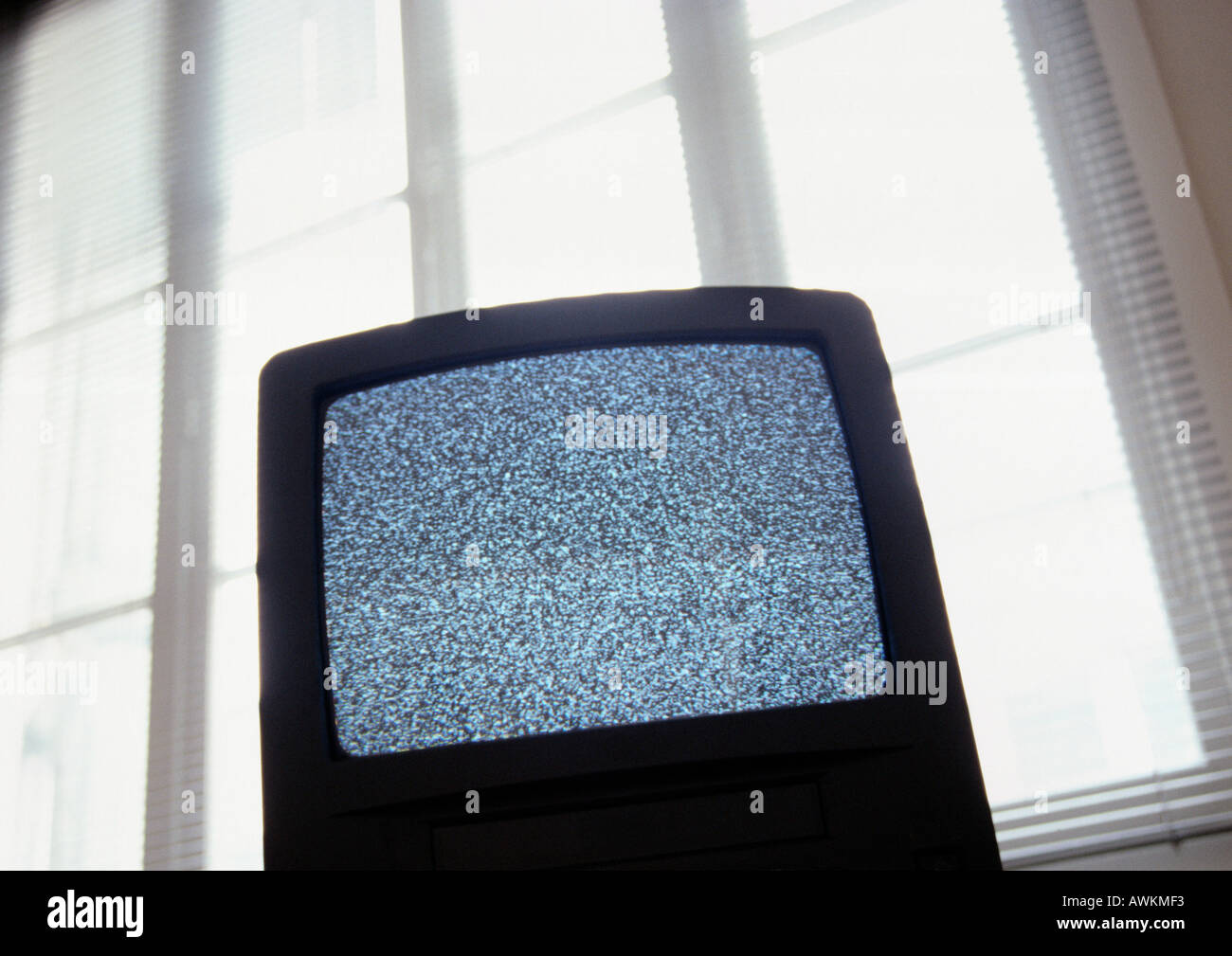 Static on television screen, back lit, low angle view Stock Photo