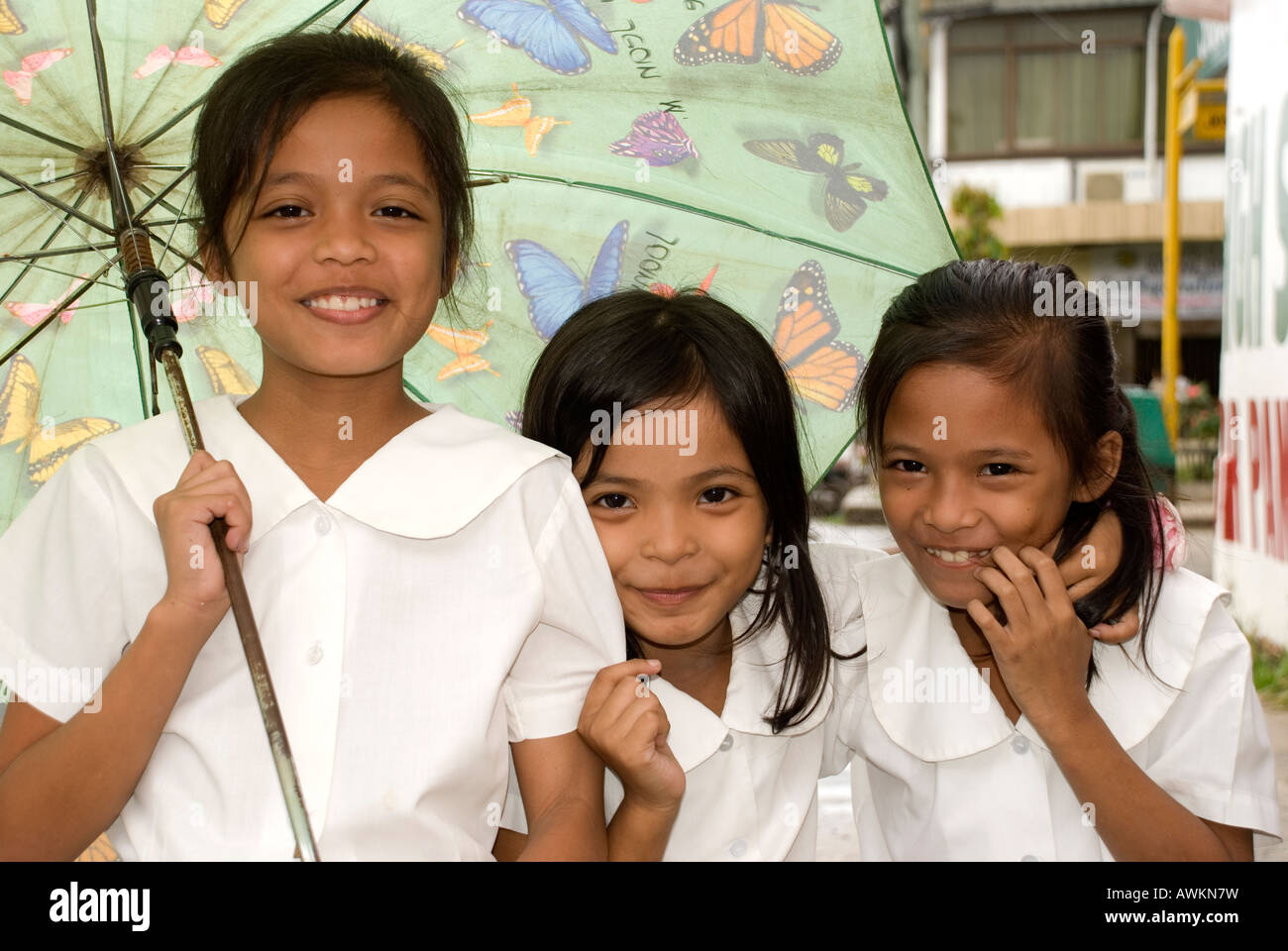 philippines island siquijor town girls with umbrella Stock Photo