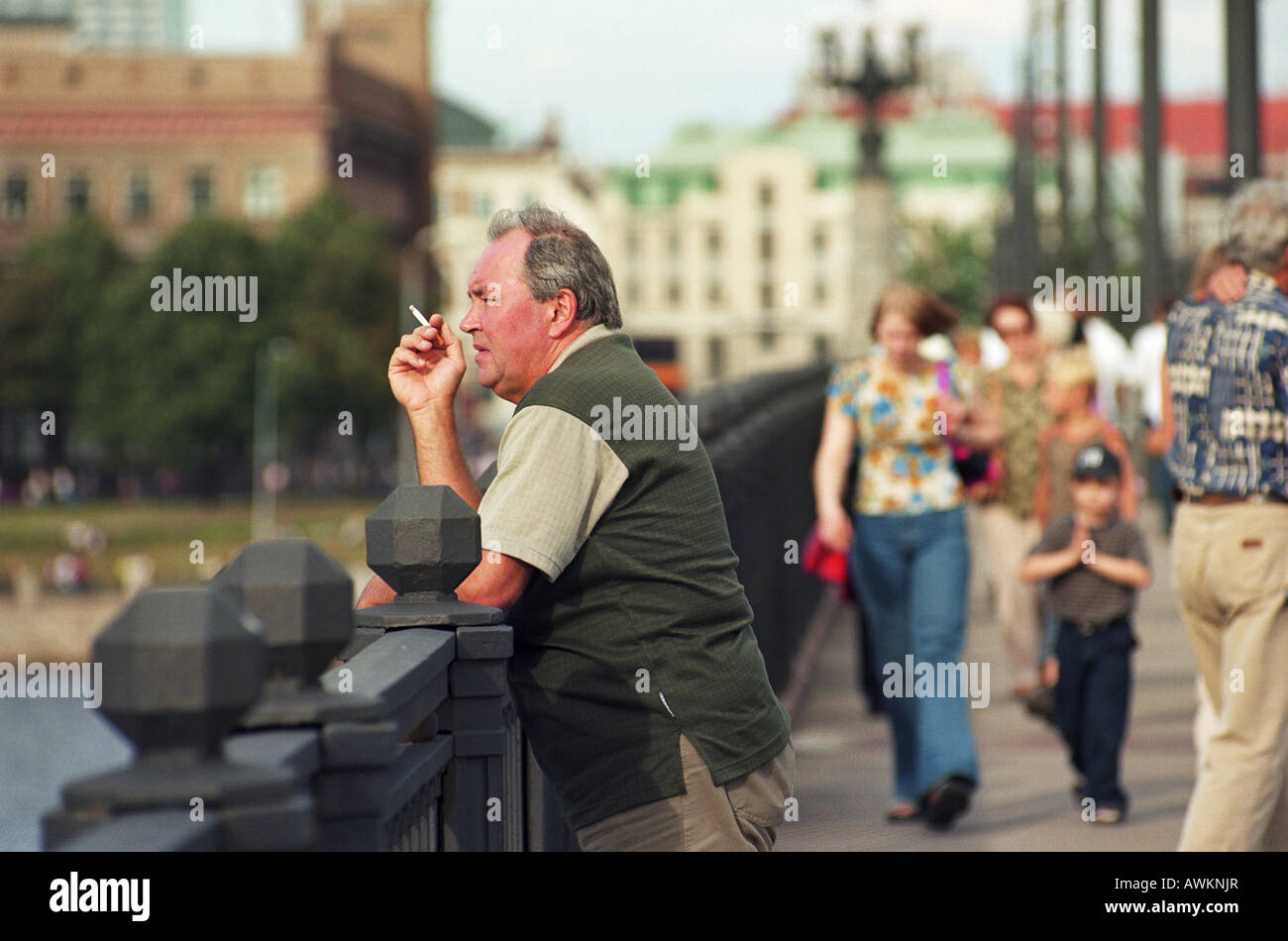 Man smoking a cigarette on a bridge in the centre of Riga, Latvia Stock  Photo