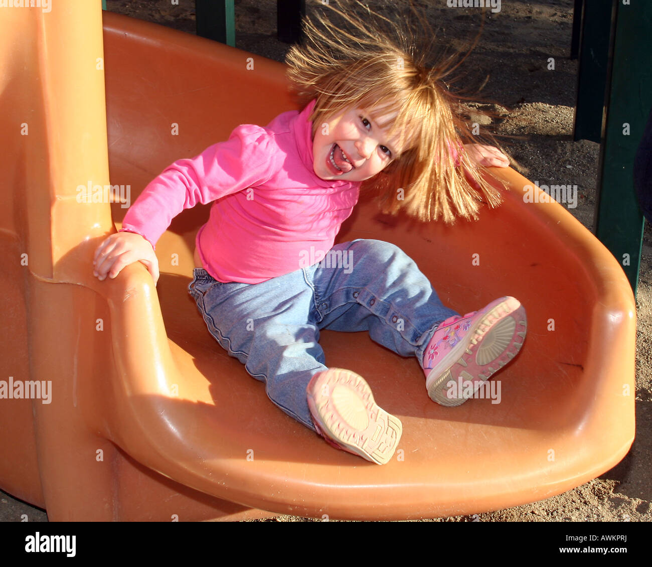 Girl with static electricity in her hair on slide Stock Photo - Alamy