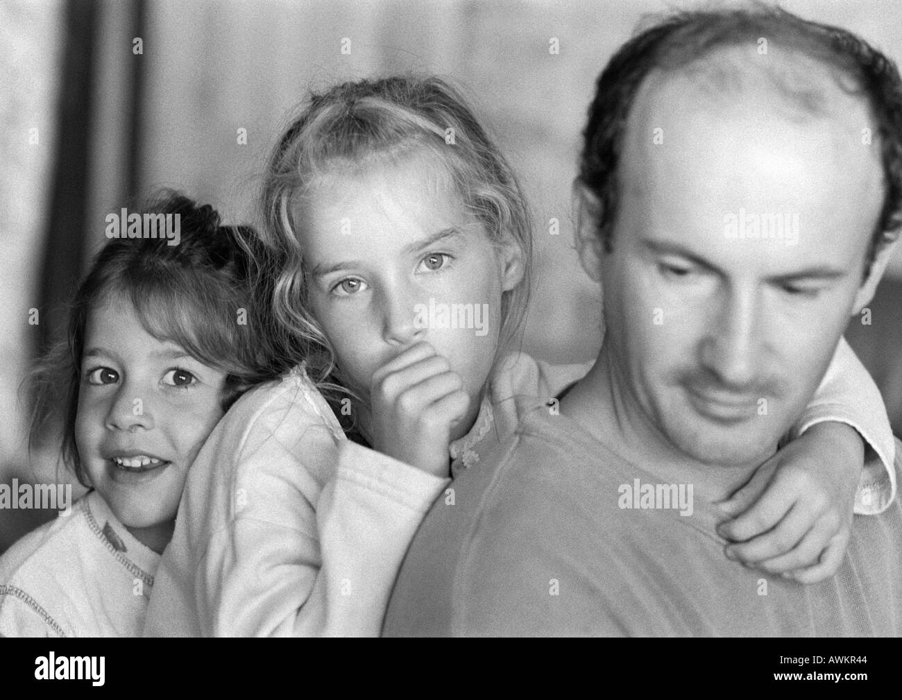 Two girls with father, b&w Stock Photo