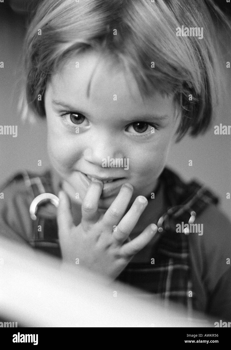 Little girl with finger in mouth, portrait, b&w Stock Photo