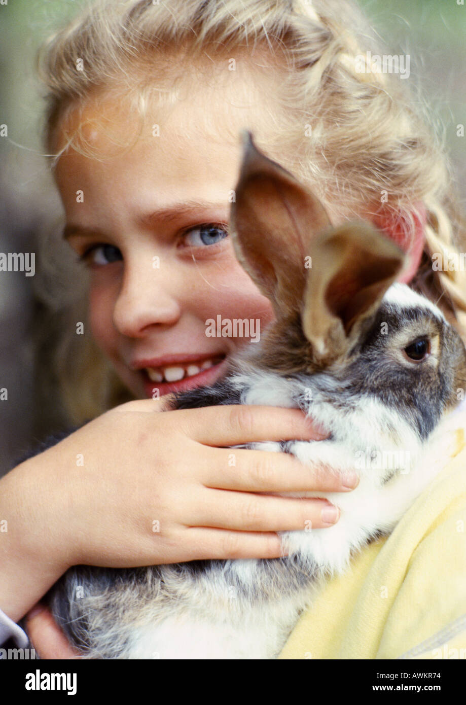Girl hugging rabbit, closeup Stock Photo Alamy