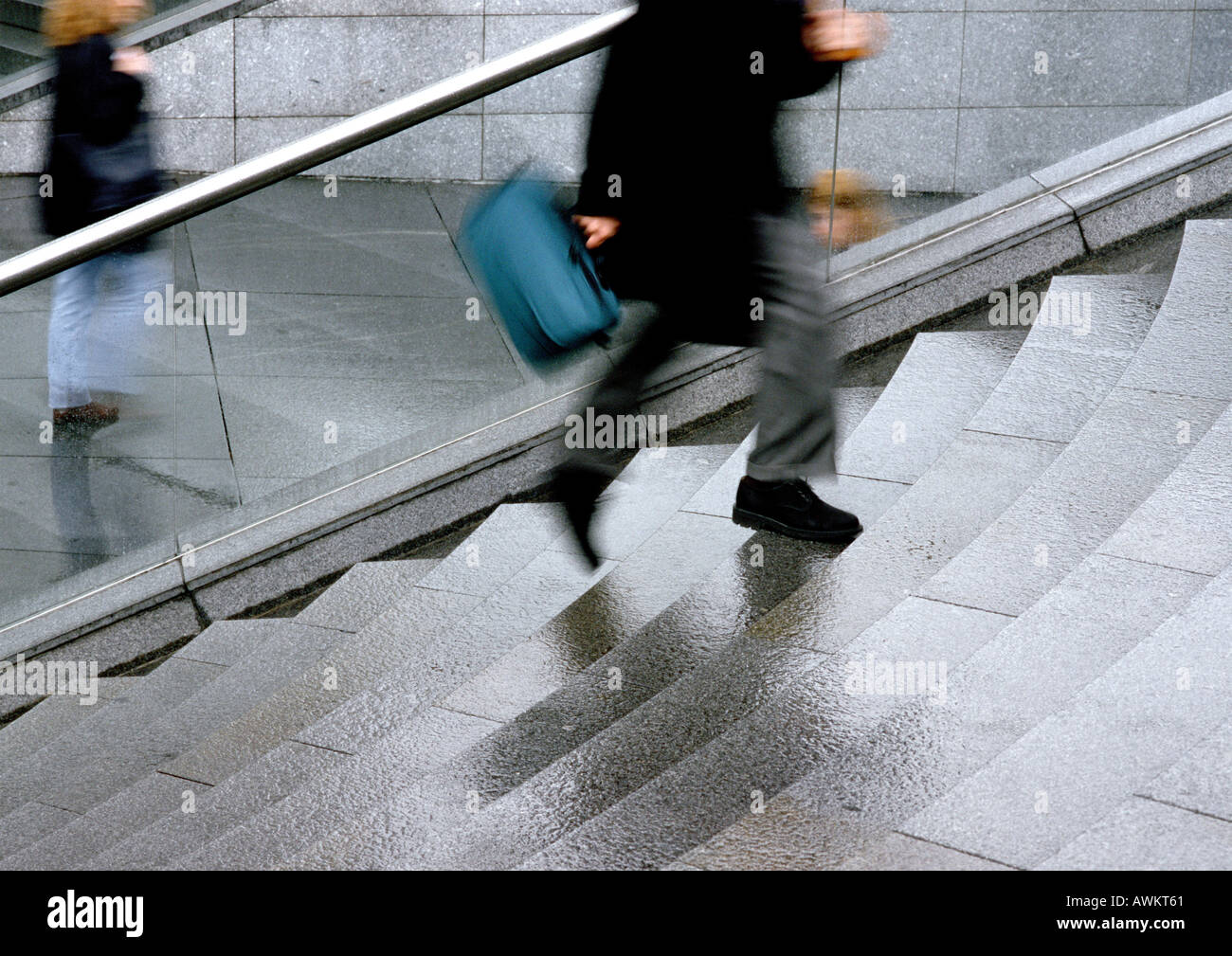 Man rushing up stairs, low section, blurred motion Stock Photo