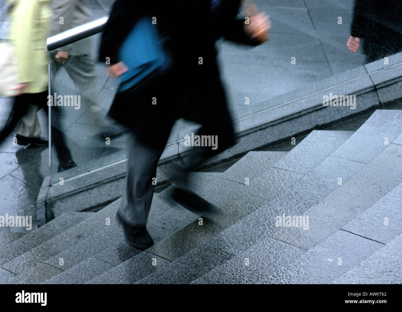 Man going up stairs, low section, blurred motion Stock Photo