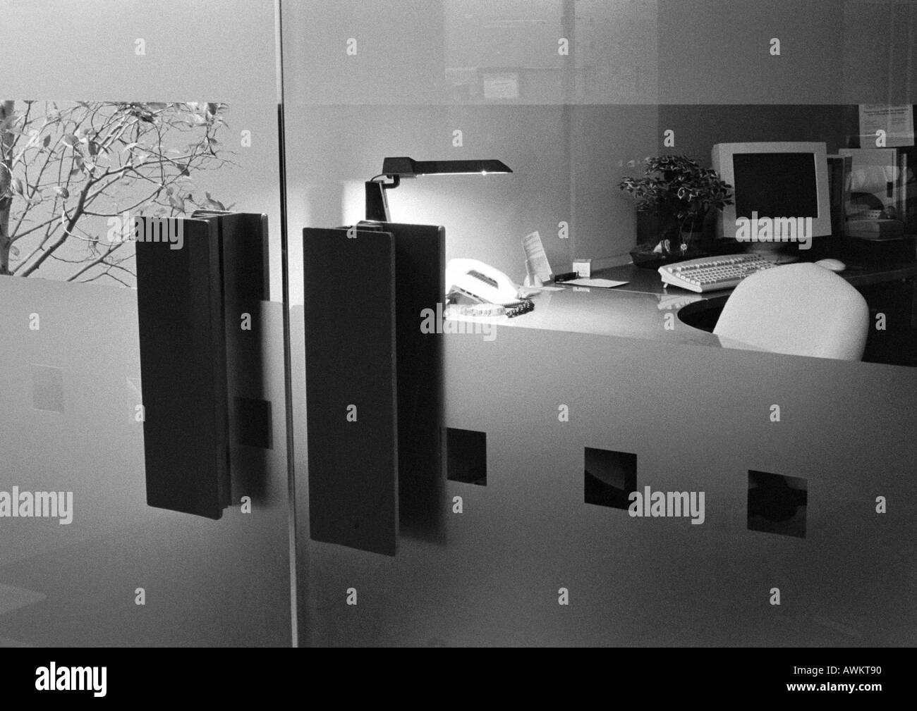 Desk behind glass doors, b&w Stock Photo Alamy