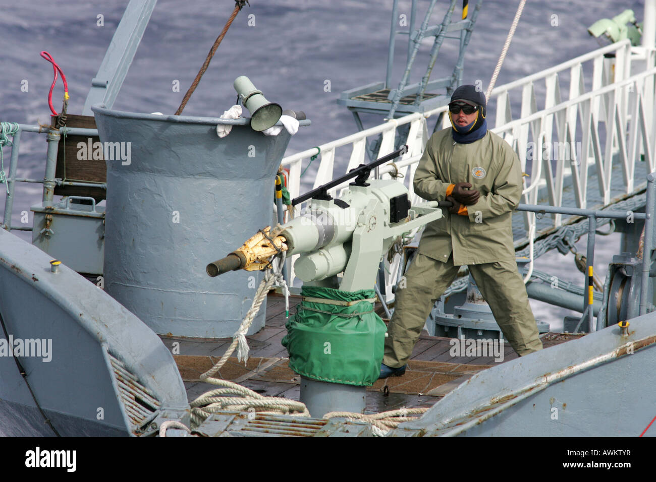 Harpoonist with harpoon aboard Japanese whaling ship, Southern Ocean. Stock Photo