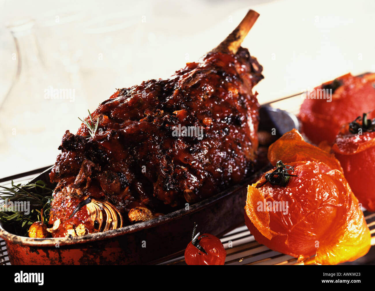 Roasted leg of lamb with tomatoes and herbs, in casserole dish, closeup Stock Photo Alamy
