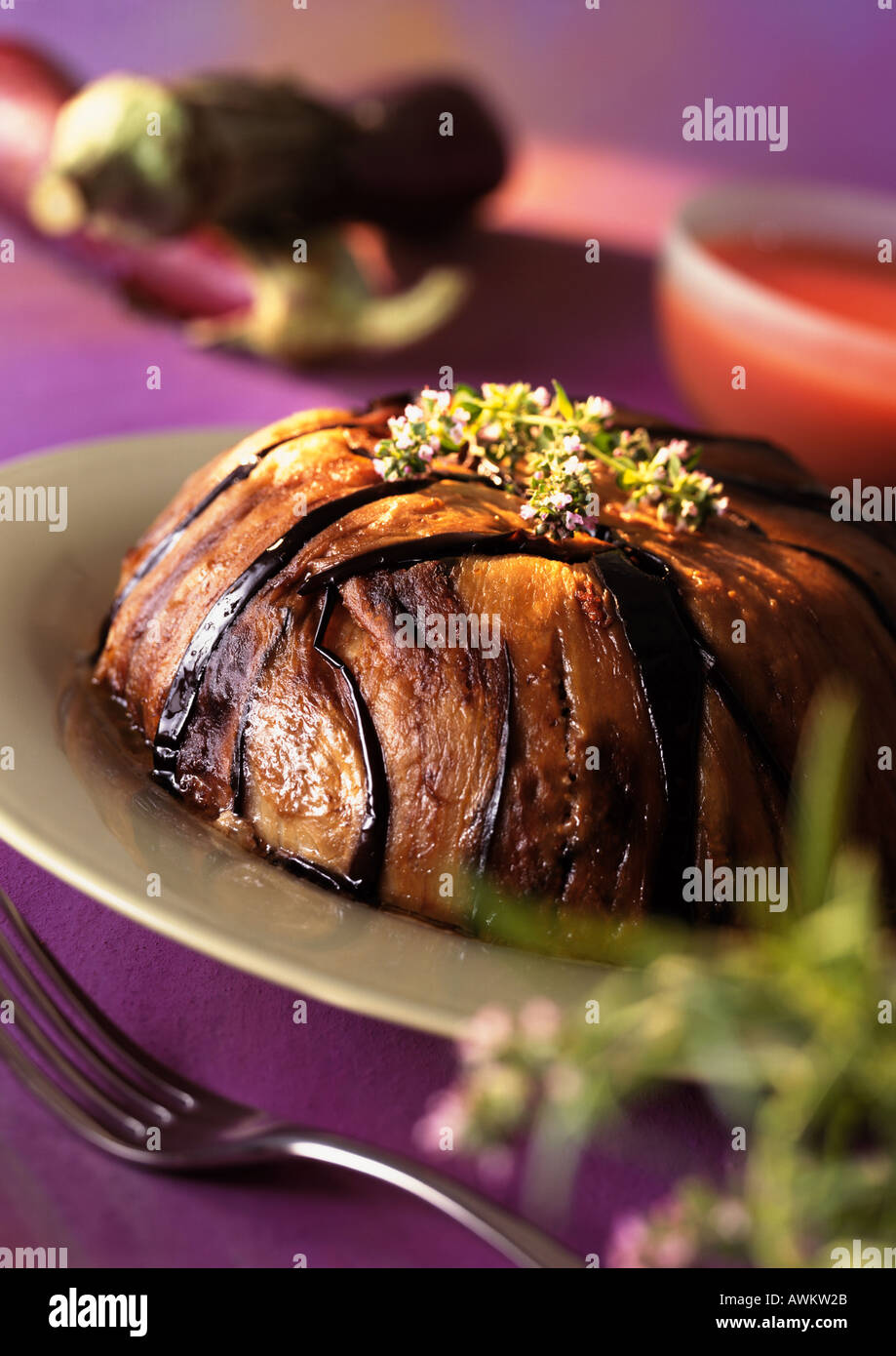 Eggplant cake on plate, topped with herbs, close-up Stock Photo