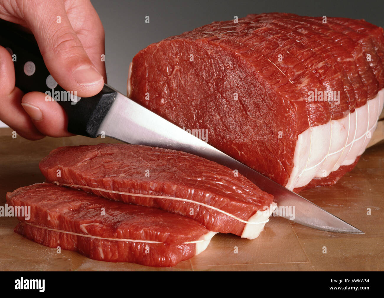 Close up hands cutting roast beef hires stock photography and images