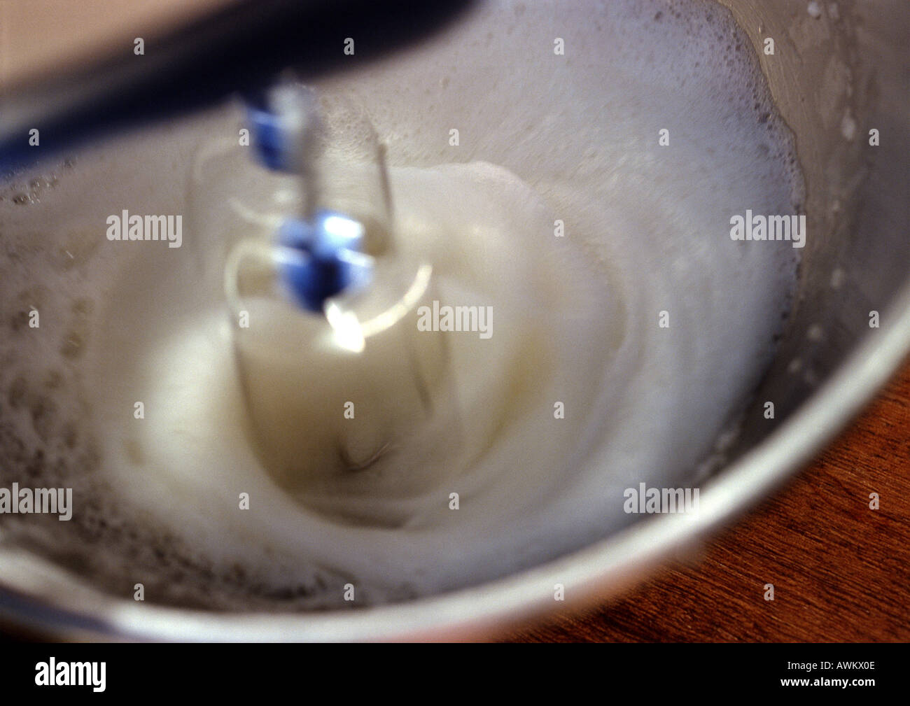 Electric mixer beating egg whites in bowl, closeup Stock Photo Alamy