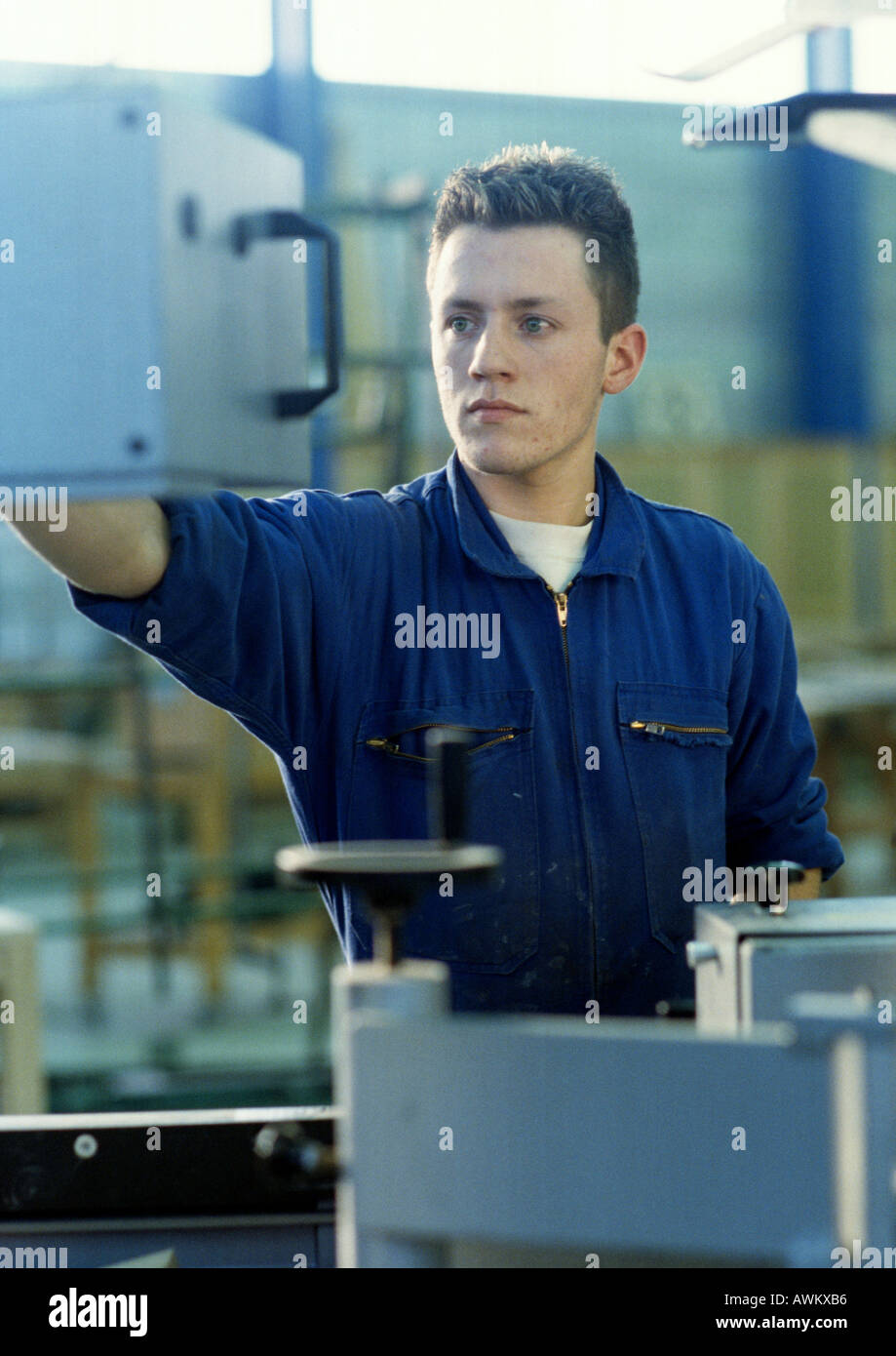 Man in coveralls in workshop Stock Photo