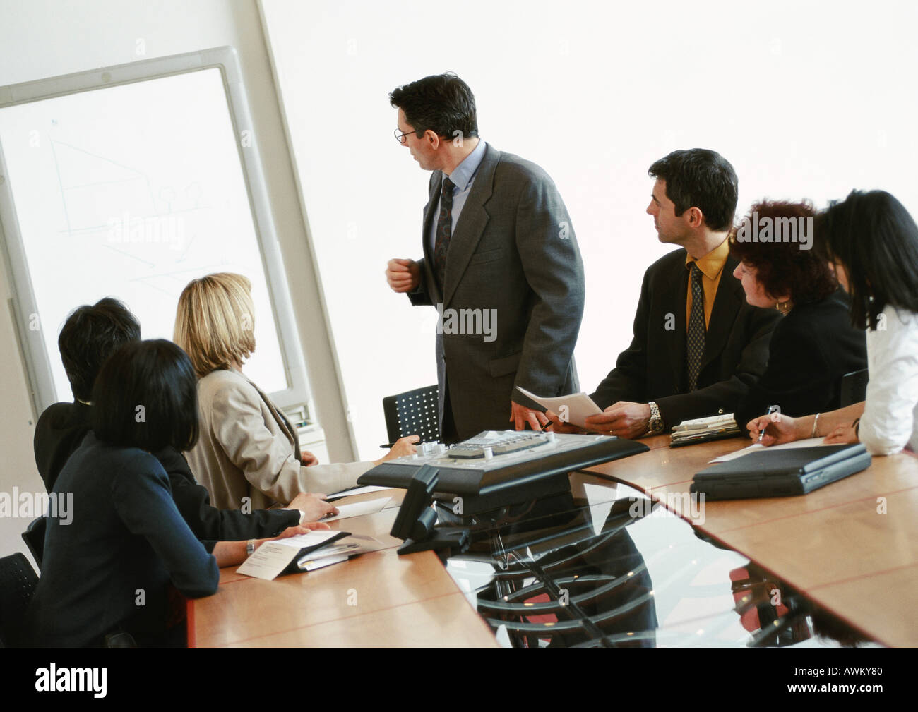 Businessman giving presentation, colleagues watching Stock Photo