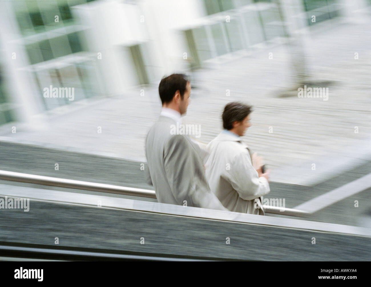 Two businessmen on stairs outside, blurred Stock Photo