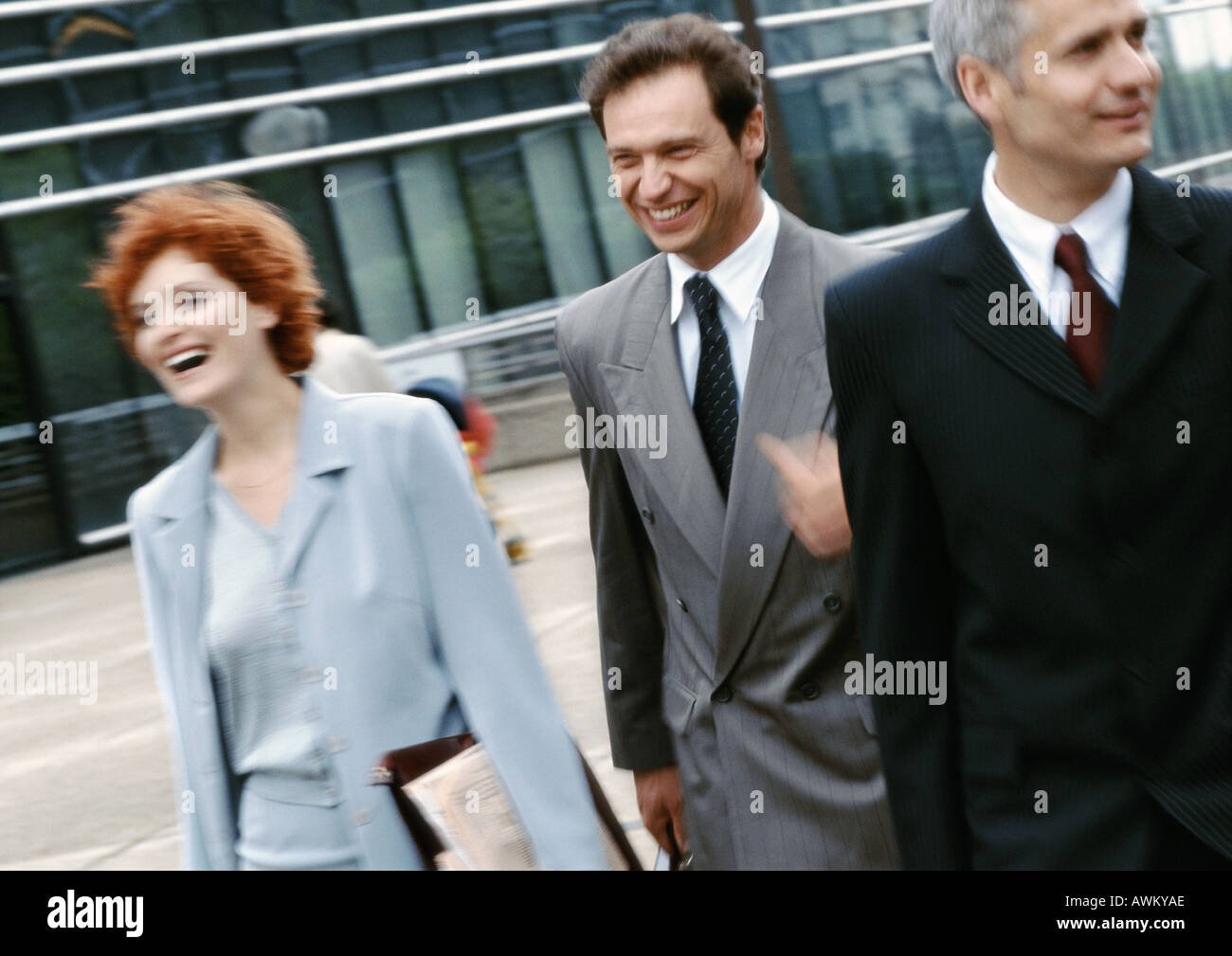 Three business people walking outside Stock Photo