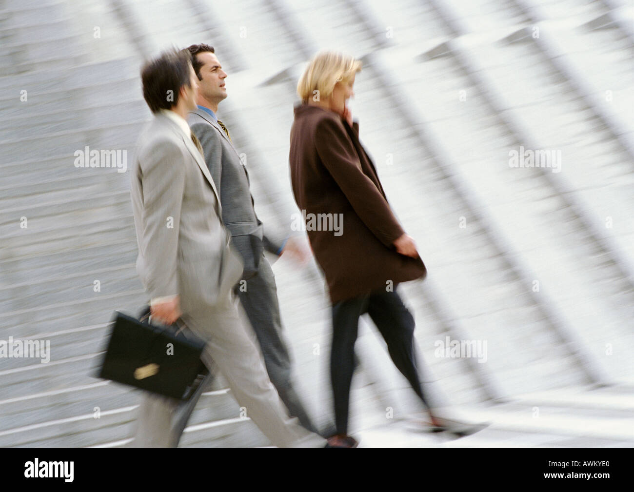 Three business people walking, blurred Stock Photo